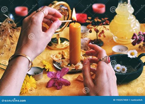 Female Wiccan Witch Wearing Vintage Jewelry Lighting A Yellow Candle On Her Litha Midsummer