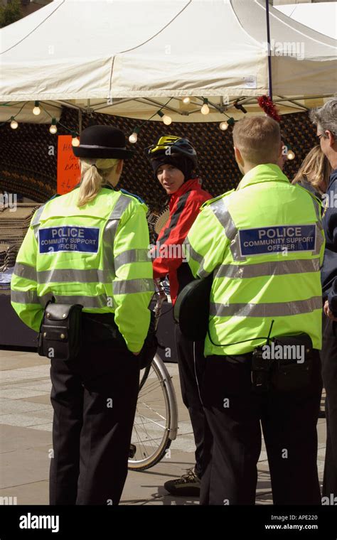 Police Community Support Officers Talking To A Member Of The Public At An Outdoor Event Stock