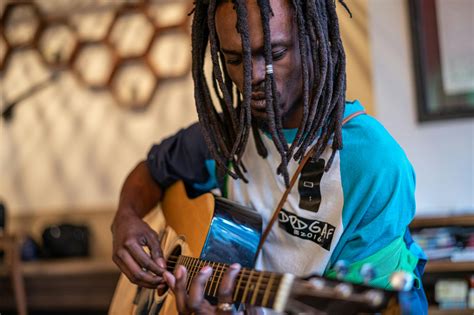 Focused black man playing guitar in studio · Free Stock Photo