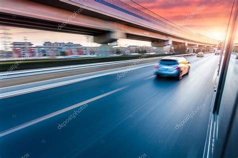 Car Driving On Freeway At Sunset Motion Blur — Stock Photo © 06photo