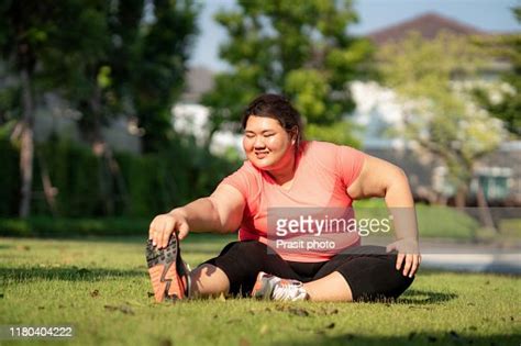 Asian Overweight Woman Exercising Stretch Alone In Public Park In