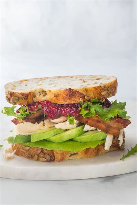 Close Up Of A Turkey And Bacon Club Sandwich With Cranberry Sauce And