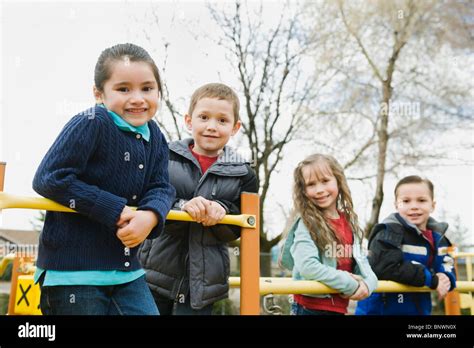 Elementary School Students Playing In Playground At Recess Stock Photo