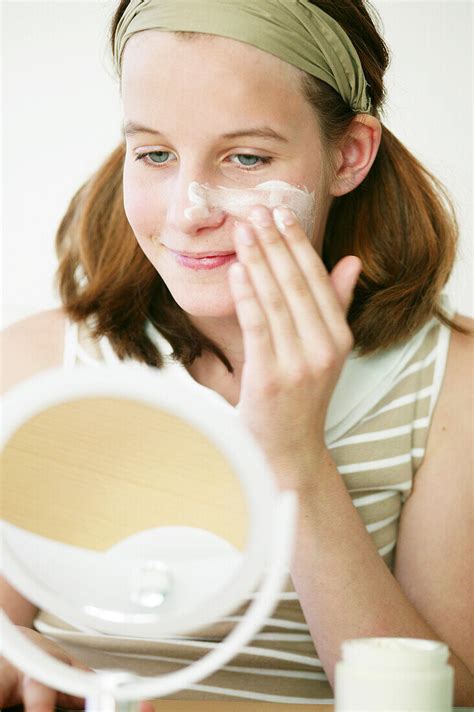 Teenage Girl Rubbing Cream Into Face License Image 70047454 Lookphotos