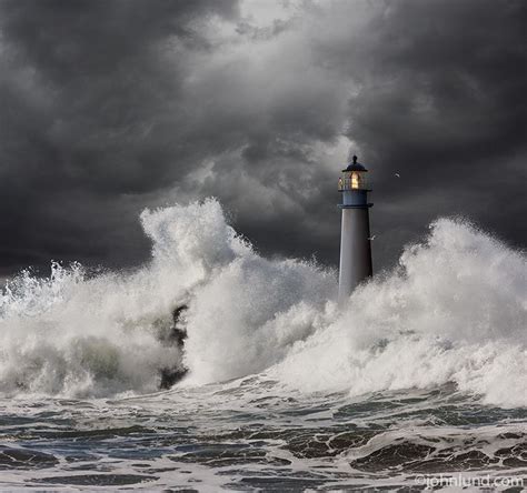 A Keeper Stands Watch Atop This Lighthouse In A Raging