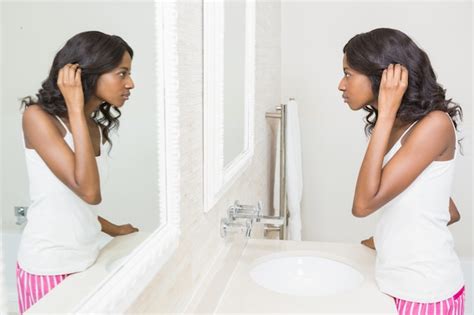 Premium Photo Young Woman Looking Her Self In Mirror
