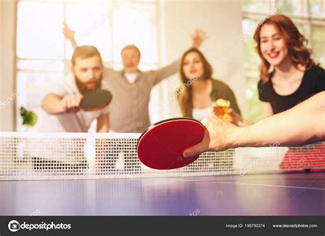 Group Of Happy Young Friends Playing Ping Pong Table Tennis Stock Photo