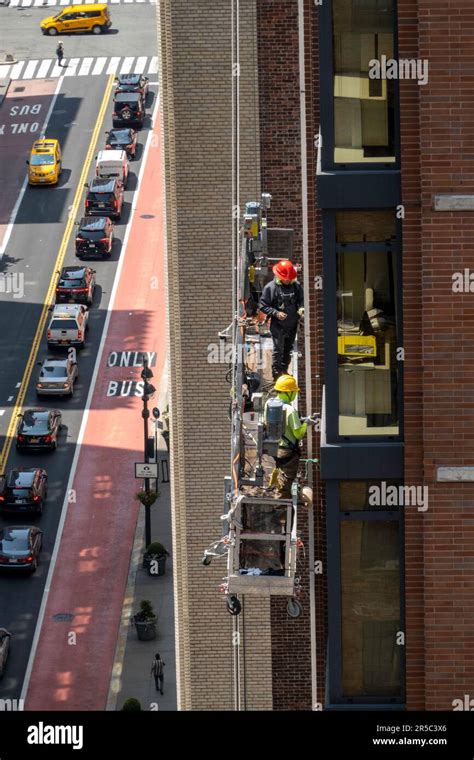 Construction Workers High Above 34th Street In New York City In A