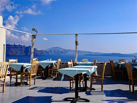Rooftop Restaurant With A View In The Town Of Oia On The Island Of