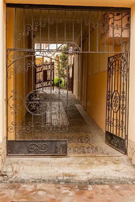 An Old Gate With A Corridor Leading To The Courtyard Of The House Stock
