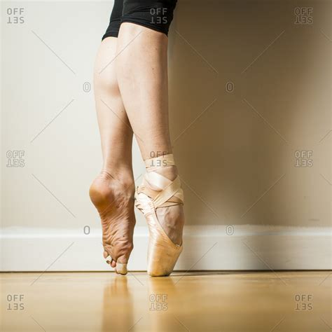 Side View Of Ballerina Wearing One Pointe Shoe Standing On Tip Toes