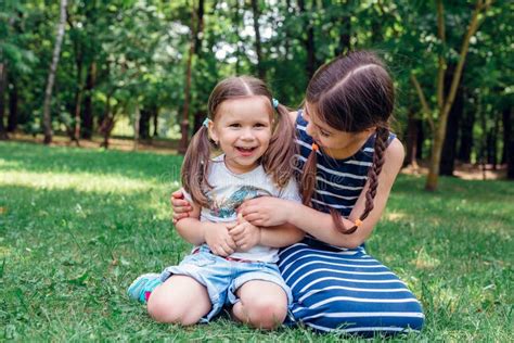 Two Cute Little Girls Having Fun In Park In Sunny Summer Day Stock