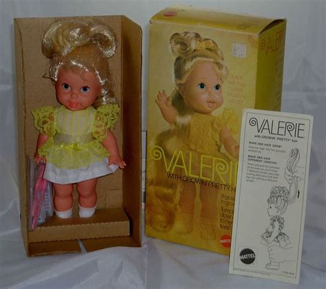 The Doll Is In Its Box And Next To Its Packaging