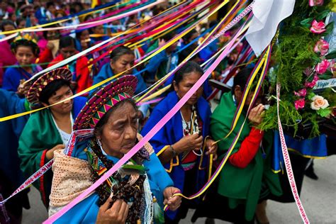 native women from the kamentsá tribe wearing colorful costumes take part in the procession