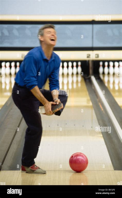 Man Dropping Bowling Ball On Foot At Bowling Alley Stock Photo Alamy