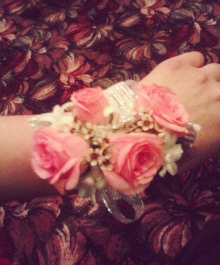 A Close Up Of A Persons Arm With Pink Flowers On Top Of It