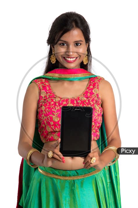 Image Of Beautiful Traditional Indian Girl Showing Smart Phone Screen