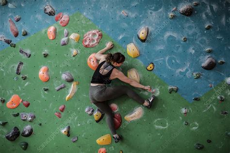 Female Rock Climber Hanging From Climbing Wall Stock Image F036