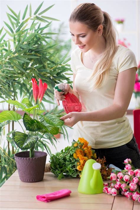 The Young Woman Watering Plants In Her Garden Stock Image Image Of