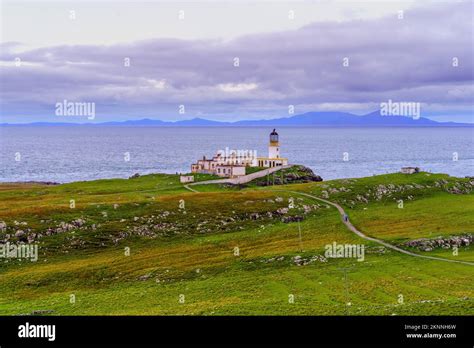Sunset View Of Neist Point Lighthouse Coastal Cliffs And Rocks In