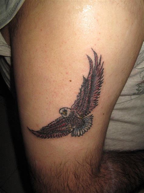 Colorful Flying Bald Eagle Tattoo On Thigh