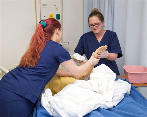 Comments and news tips are welcome. CNA nursing students in lab - NWCCD