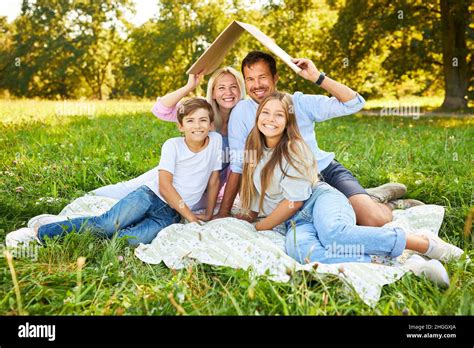 Children and parents with a roof over their heads as a symbol for home