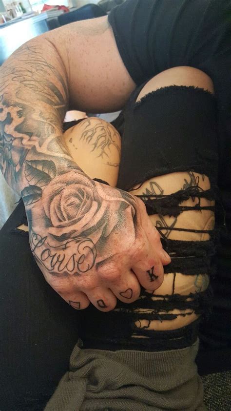 A Man With Tattoos On His Arm And Chest Is Holding Onto Another Person