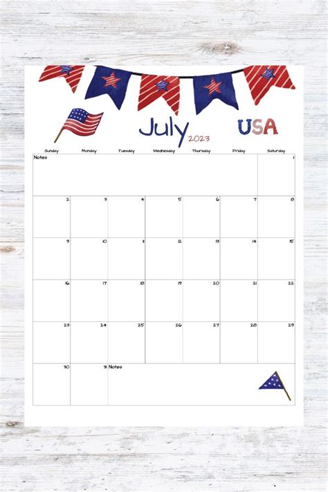 The July Usa Calendar Is Shown On A Wooden Surface With An American