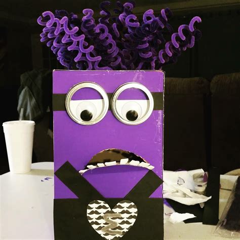 A Paper Bag With Purple Flowers In The Shape Of A Heart And Eyes On It