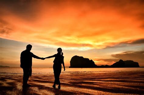 Romantic Couple Holding Hands At Sunset On Beach Stock Photo Image