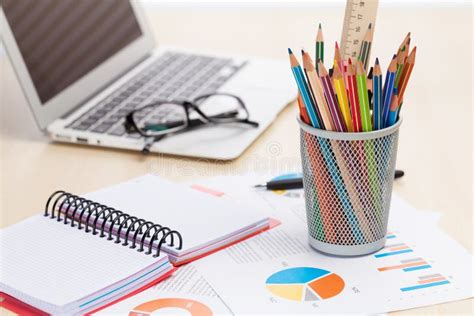 Office Desk Workplace With Laptop Reports And Pencils Stock Photo