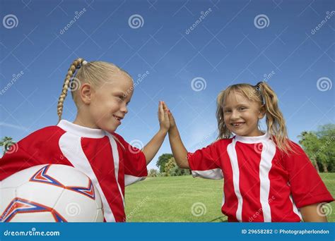 Girls Giving A High Five On Soccer Field Stock Photo Image Of