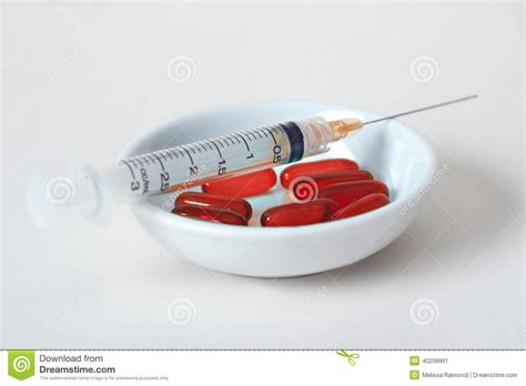 needle syringe with red pills in bowl stock image image of needle health 40209961