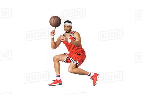 Young Basketball Player Spinning Ball On Finger Isolated On White