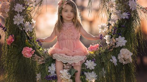 Cute Little Girl On Flower Swing Wearing Peach Color Dress