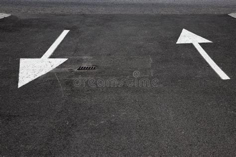 Two Arrows Painted On Street To Show Two Way Traffic Directions Stock