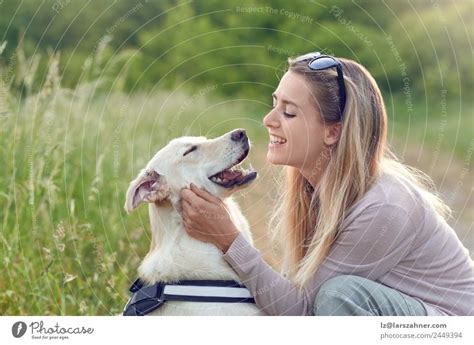 Attractive Smiling Blond Woman With Her Two Dogs A Royalty Free Stock