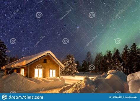 Winter Landscape With Wooden House Under A Beautiful Starry Sky Stock