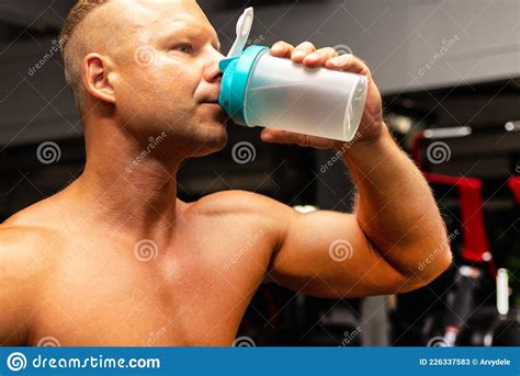 Young Caucasian Man Drinking Water After Exerciseman In The Gym