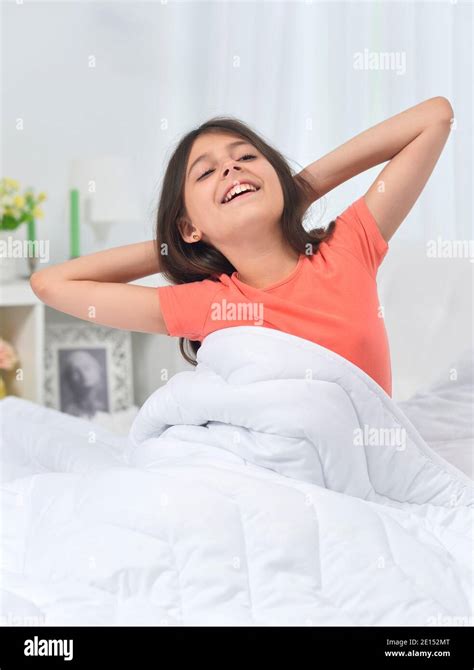 Cute Little Girl Waking Up In Bed Stock Photo Alamy