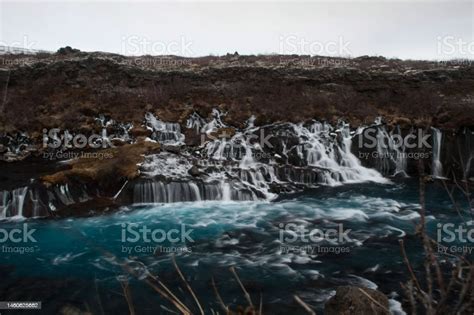 Panorama Long Exposure Of Turquoise Deep Blue Hraunfossar Waterfall