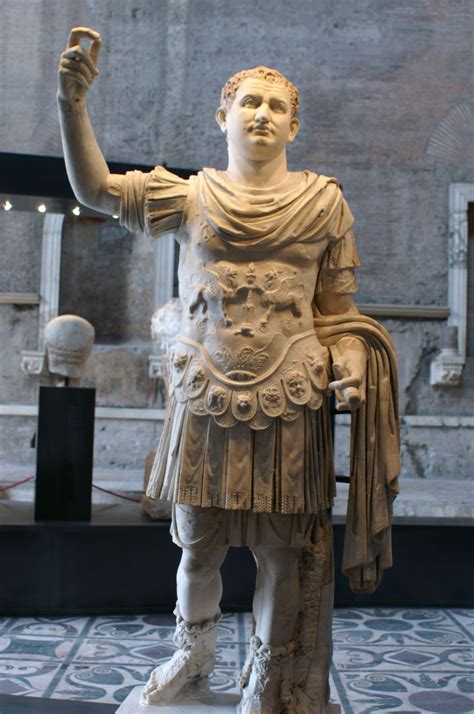 A Statue Of A Man Holding A Cup In One Hand And An Arm In The Other