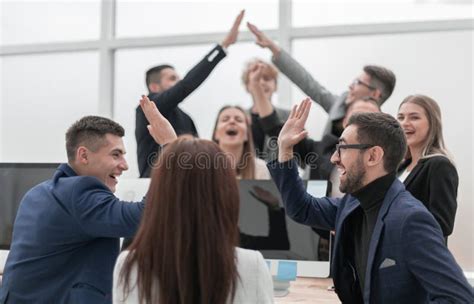 Group Of Young Business People Giving Each Other A High Five Stock