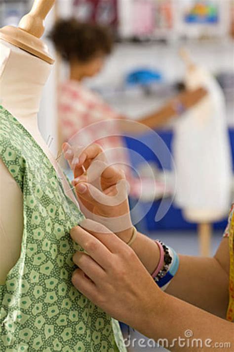 Serious Student Sewing Clothing In Home Economics Classroom Stock Image