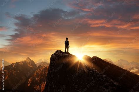 A Man Standing On Top Of A Mountain As The Sun Sets Goals And