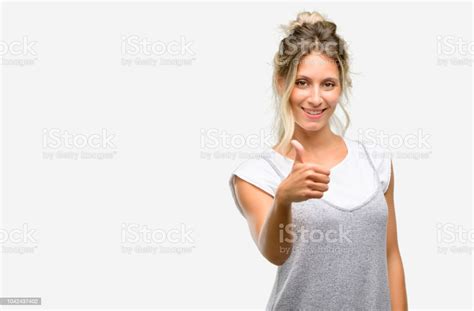 Young Beautiful Woman Smiling Broadly Showing Thumbs Up Gesture To