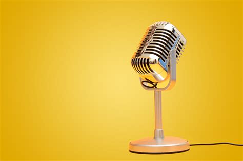 Retro Vintage Microphone On Yellow Background Studio Stock Photo