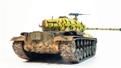 A Toy Army Tank On A White Background