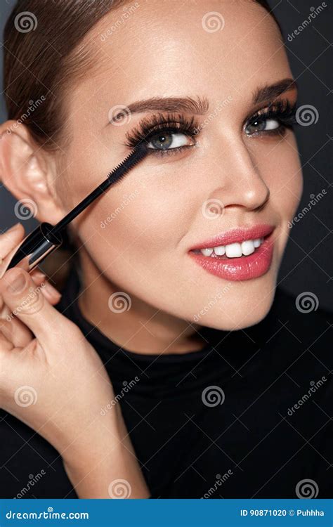 Cosmetics Beautiful Woman With Perfect Makeup Applying Mascara Stock